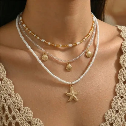 Boho Mehrschichtige Muschel-Seestern-Anhänger-Halskette für Frauen Handgefertigte Perlen-Imitationsperlen-Choker Strandparty-Schmuck Geschenk So ist Leben