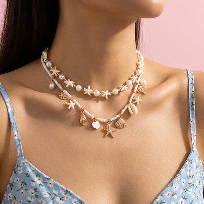 Boho Mehrschichtige Muschel-Seestern-Anhänger-Halskette für Frauen Handgefertigte Perlen-Imitationsperlen-Choker Strandparty-Schmuck Geschenk So ist Leben